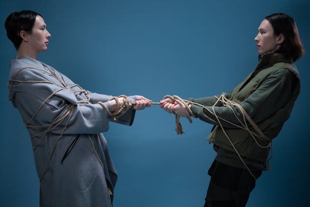 Foto de dois homens enrolados em cordas fazendo cabo de guerra e criando resistência. A imagem ilustra o artigo O que é psicanálise? Pronto para uma jornada de autodescoberta? escrito para o blog do site Online Psicanalista.